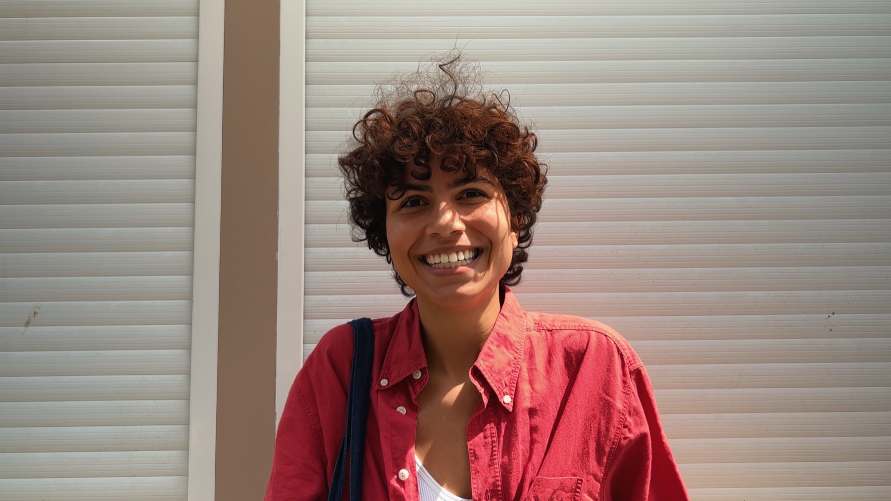 A woman smiling in the street